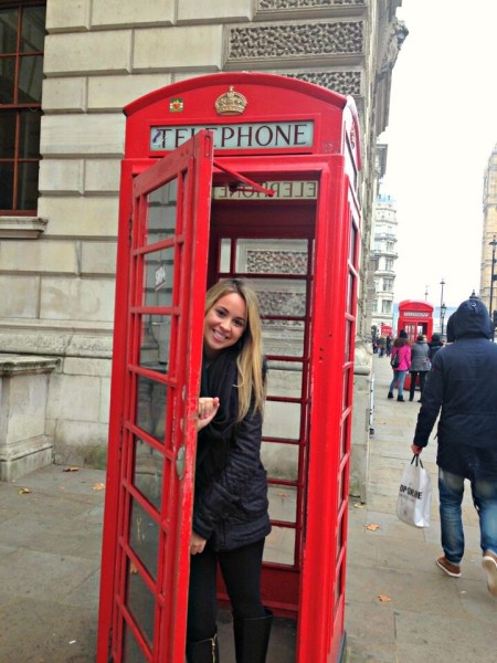 Student in phone booth in England